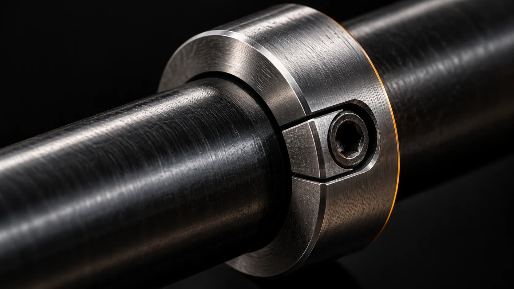 Machined steel safety stop collar on a dark shaft.