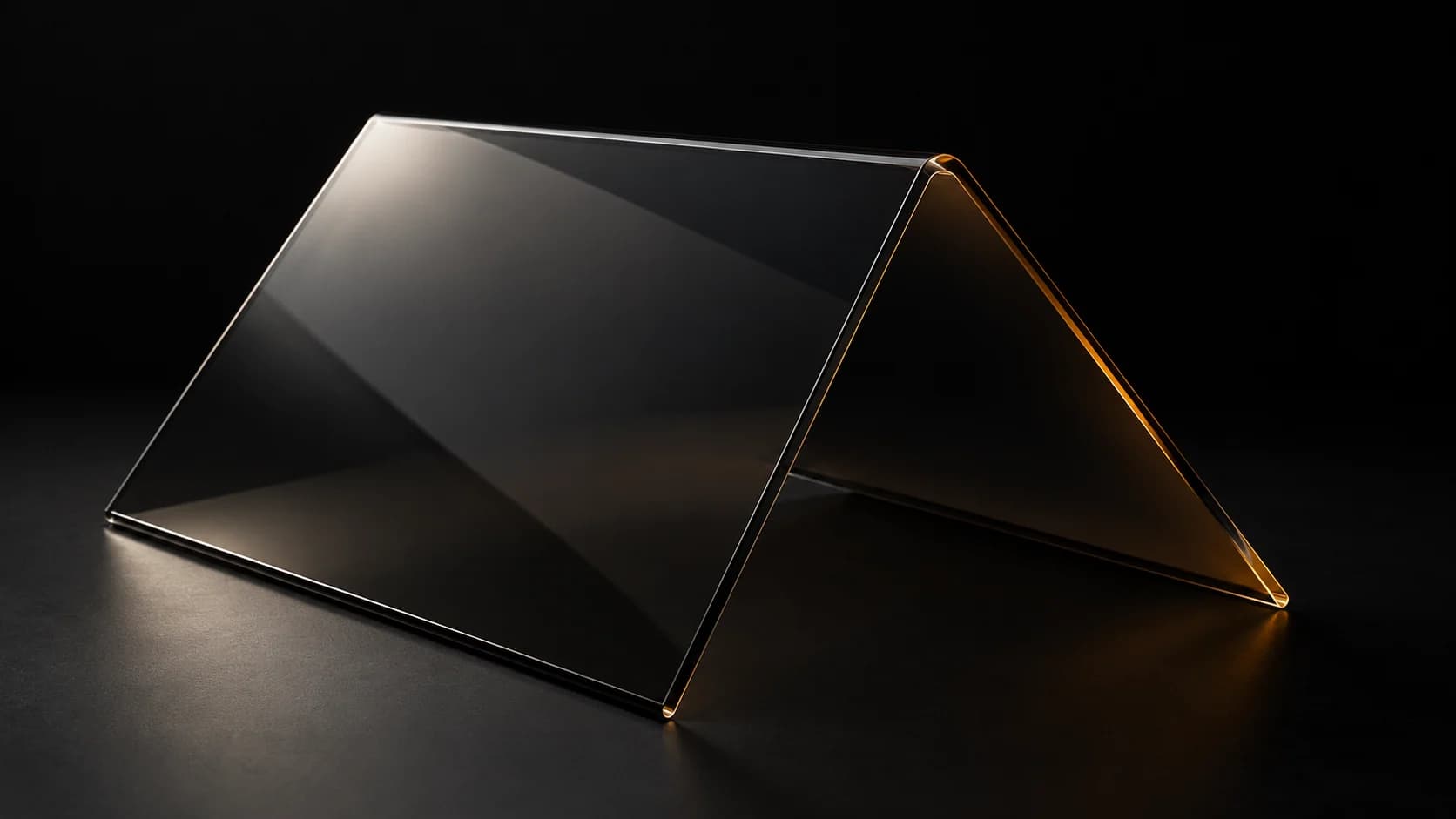 Folded smoked-glass sheet with a crisp angular crease.